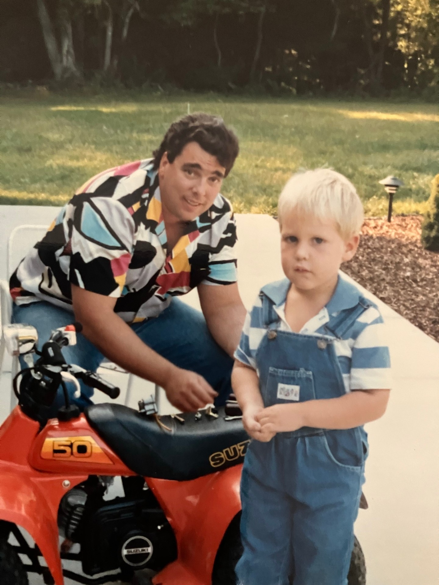 Bryan as a kid with his dad and a Suzuki 50 — where it all started